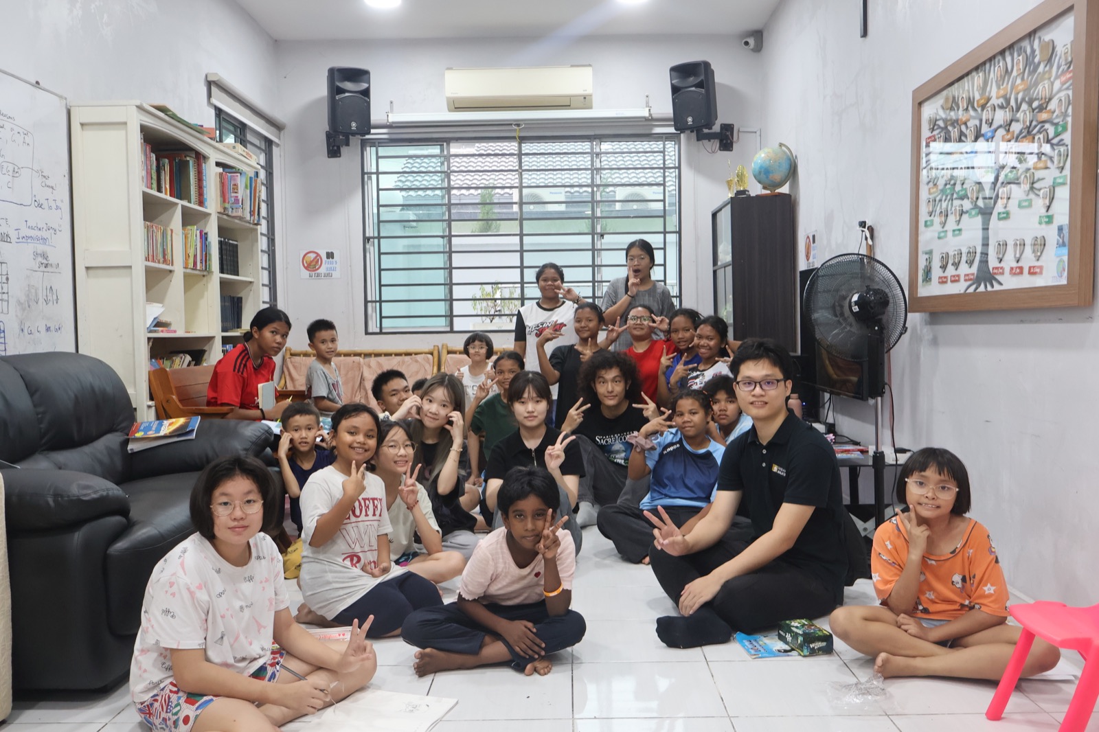 Faculty volunteers with children at a local children's home